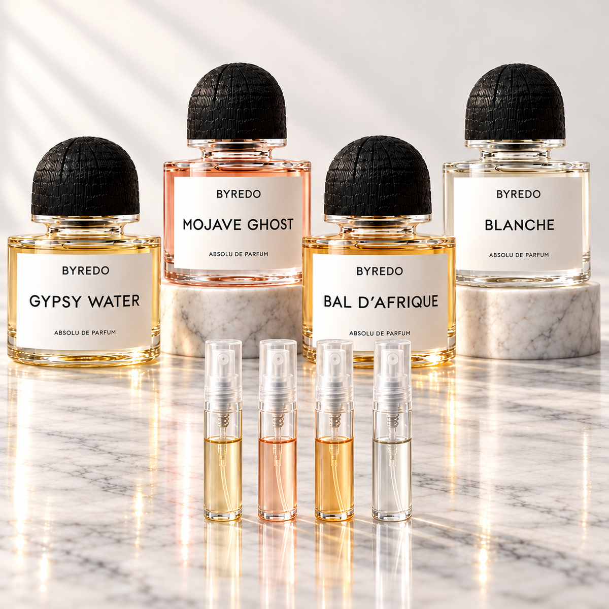 Byredo Absolu discovery set on marble with Gypsy Water, Mojave Ghost, Bal d'Afrique and Blanche bottles and four 2ml sample vials